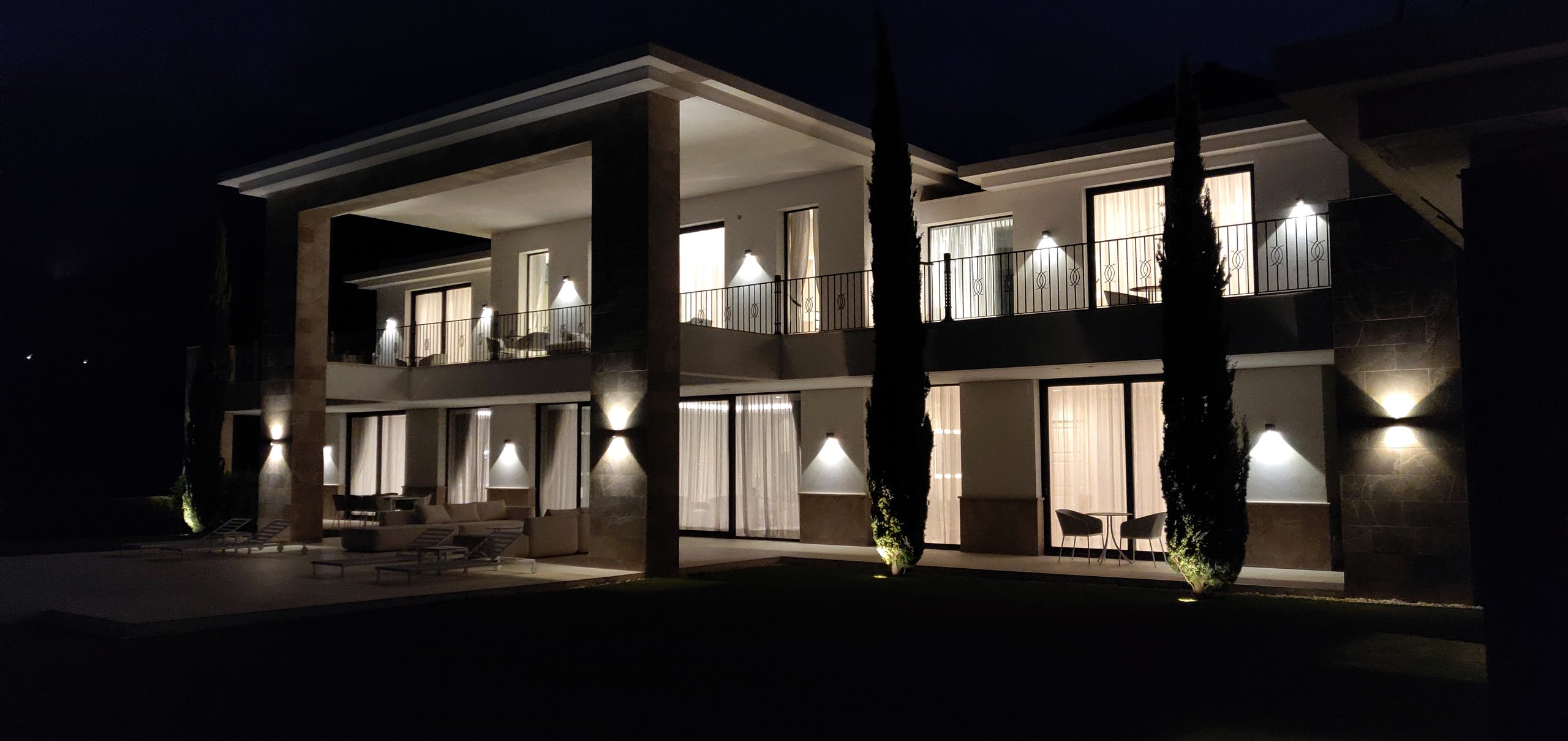 Rear exterior of a modern villa illuminated at night