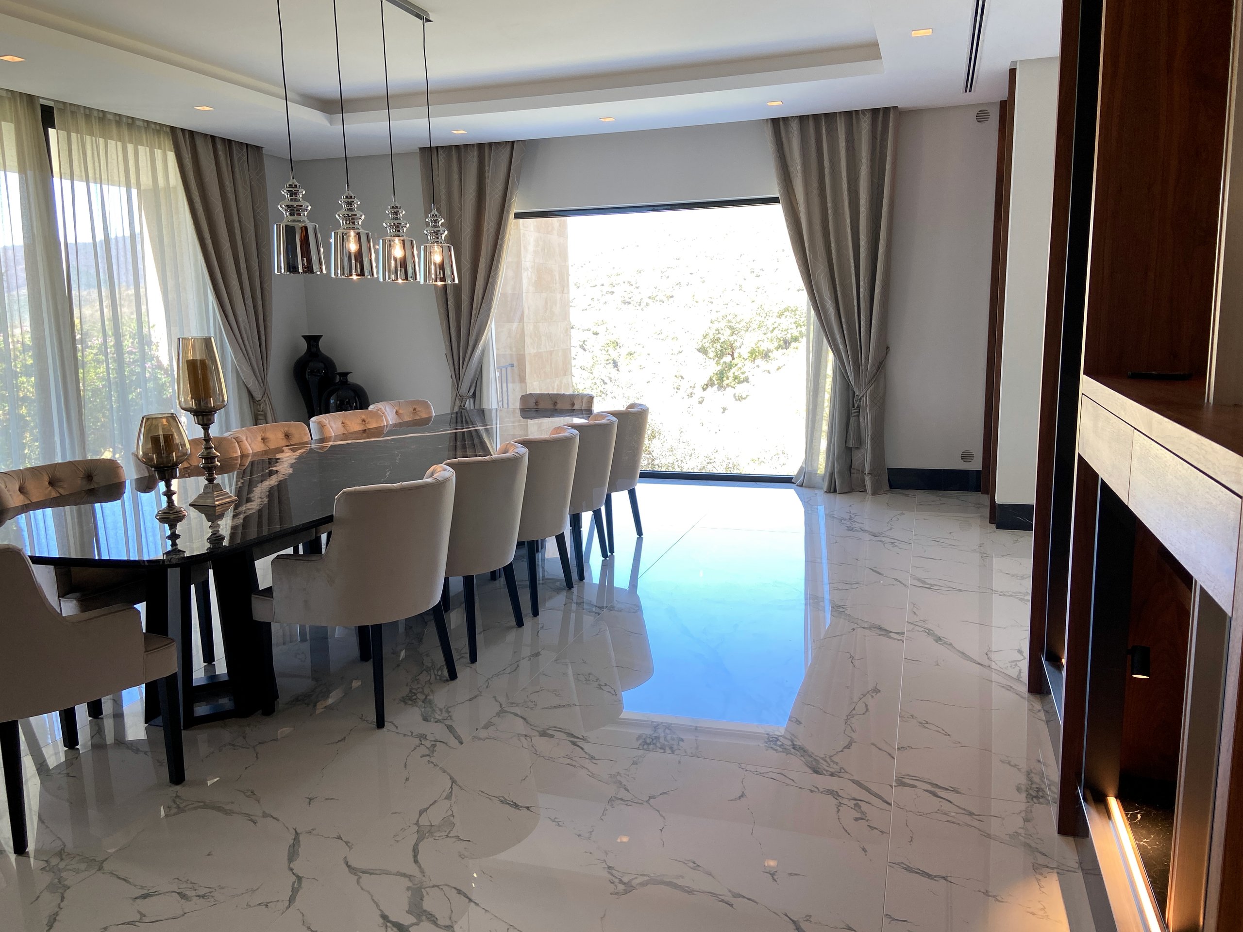 Open-plan villa dining room with integrated ceiling and pendant lighting