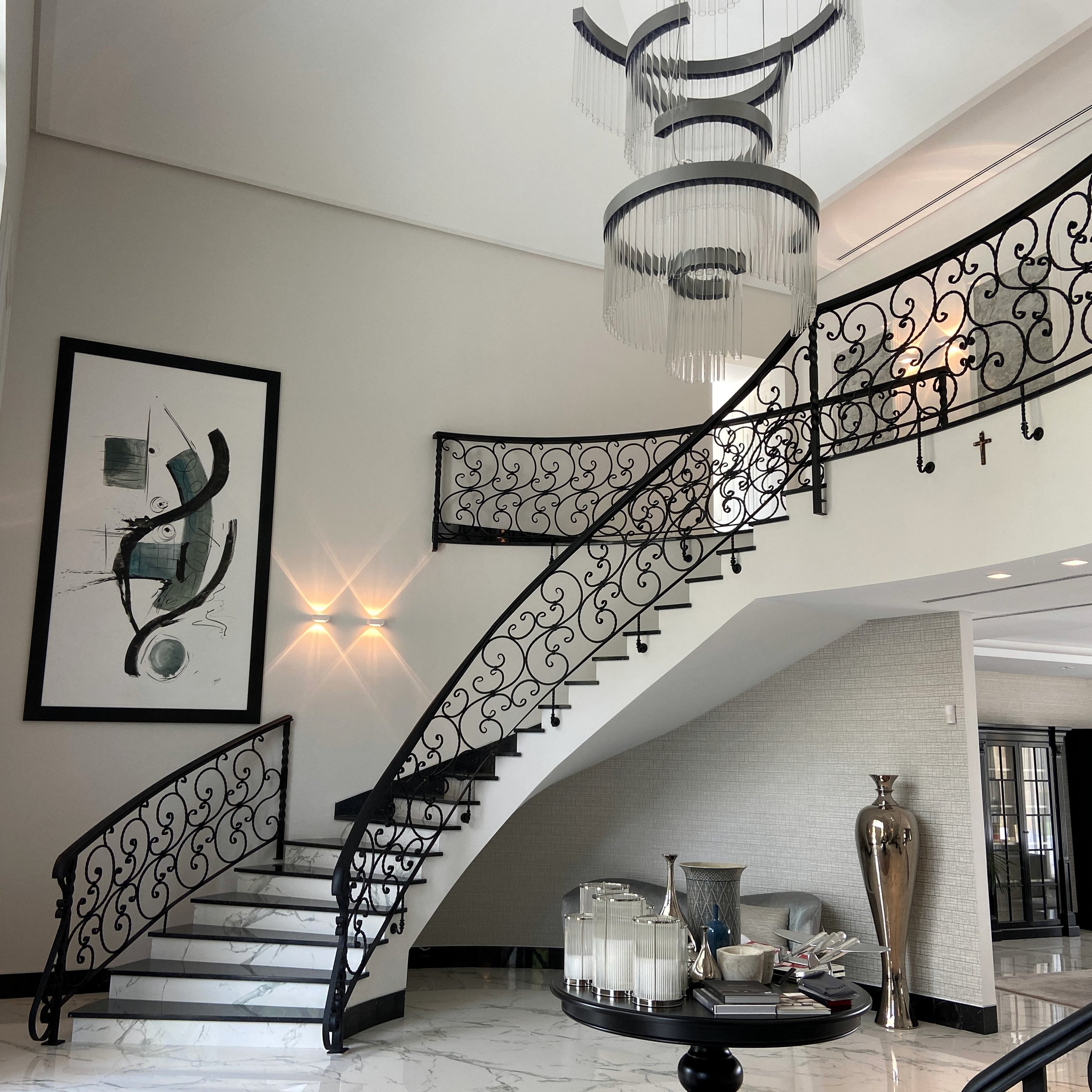 Villa staircase with decorative balustrade and feature chandelier