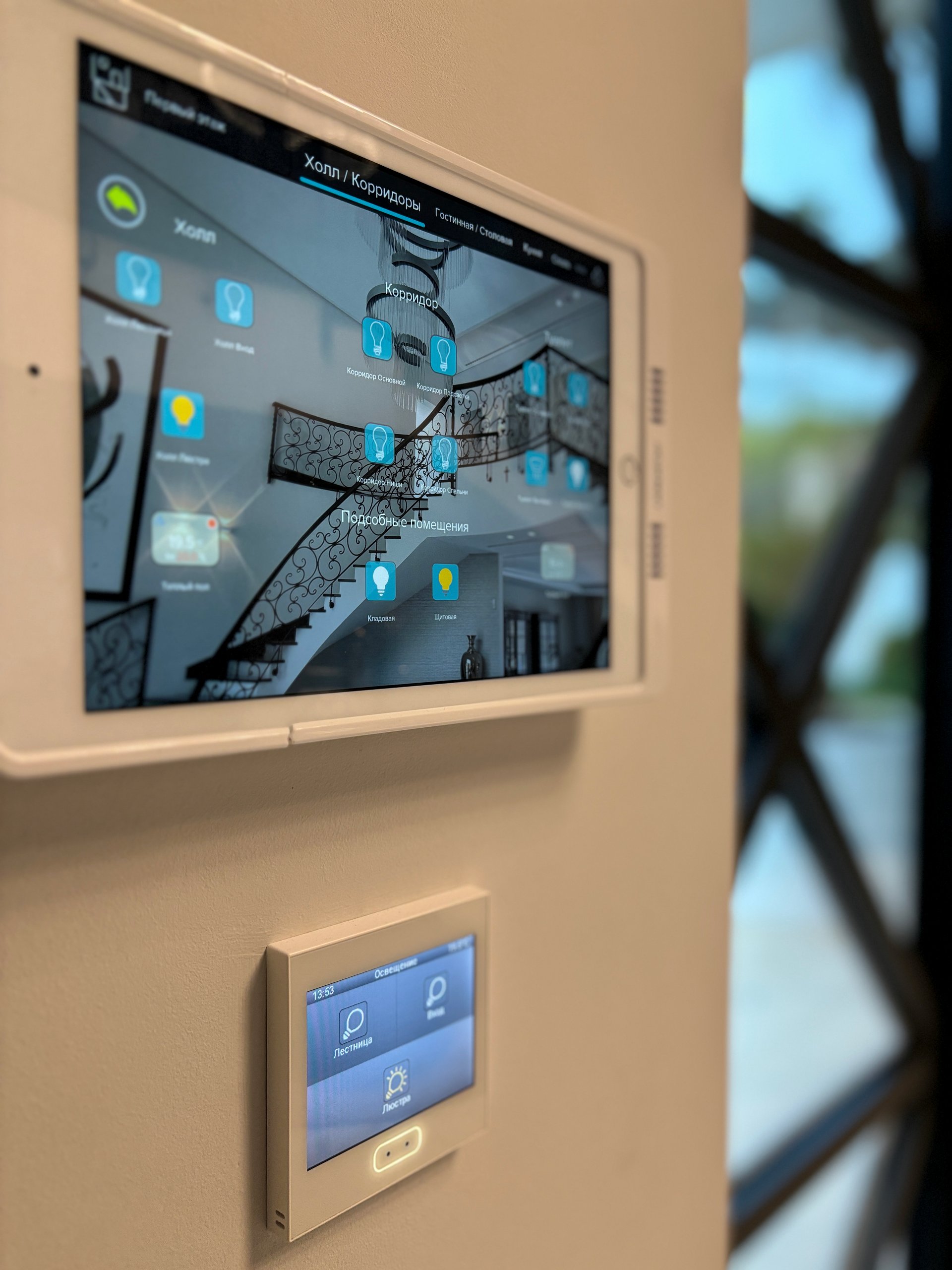 Wall-mounted smart home control panels in the villa hallway