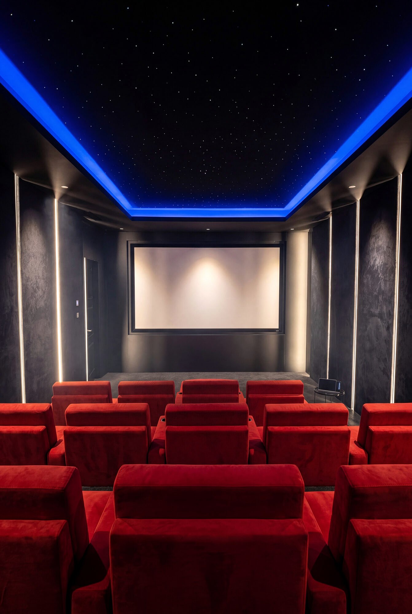 Dedicated home cinema with tiered seating and star ceiling lighting