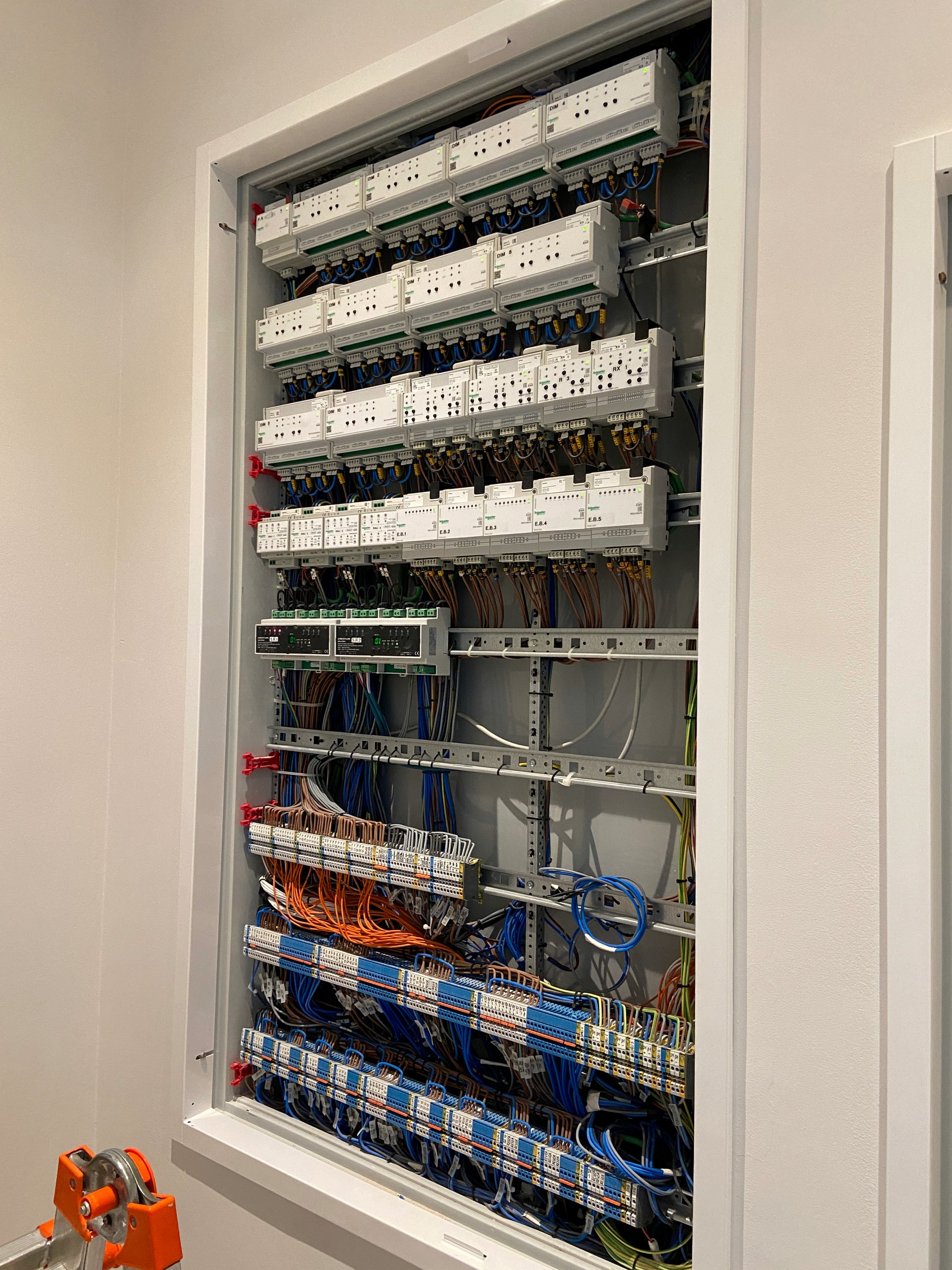 Full smart home automation cabinet with lighting control modules and wiring