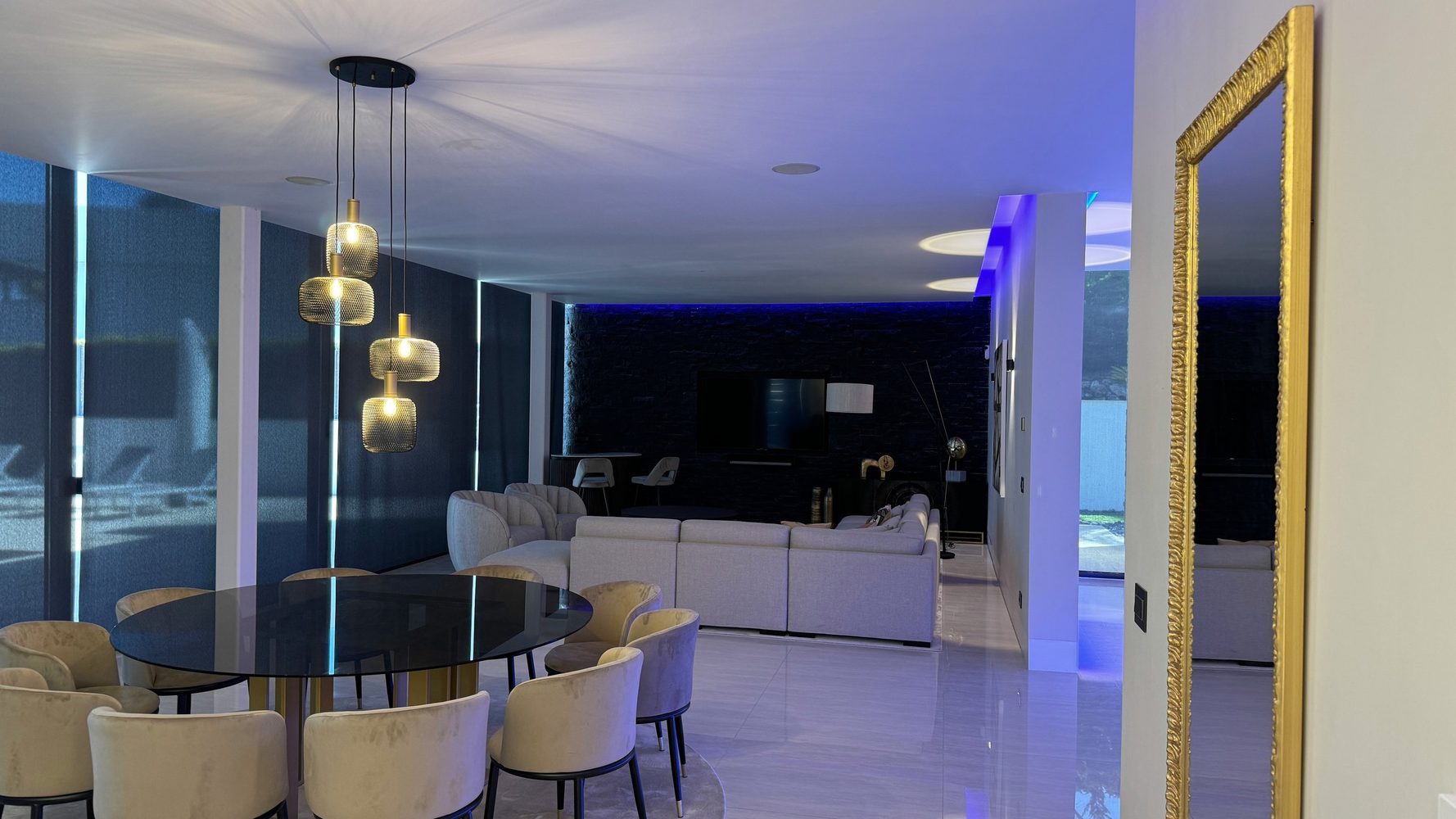 Open-plan dining and living area with an integrated lighting scene