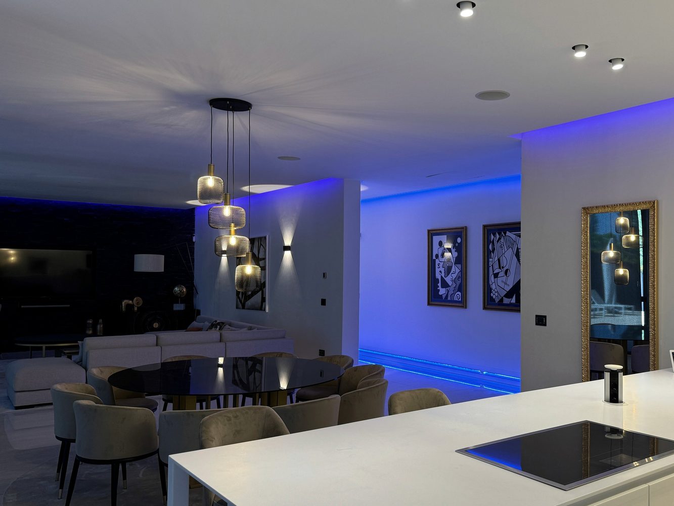 Kitchen and living area illuminated by layered smart lighting