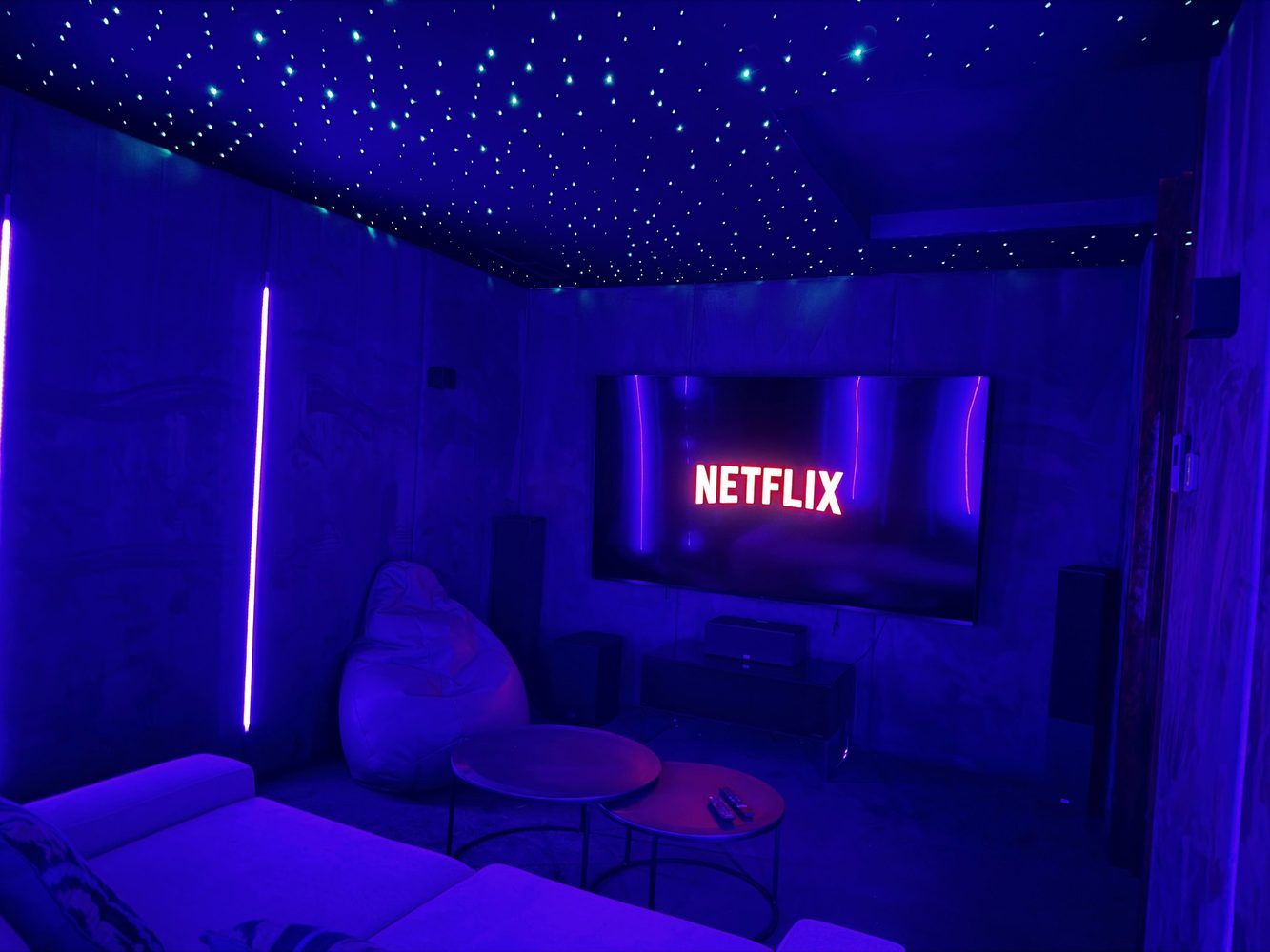 Home cinema with star ceiling, surround sound and blue lighting