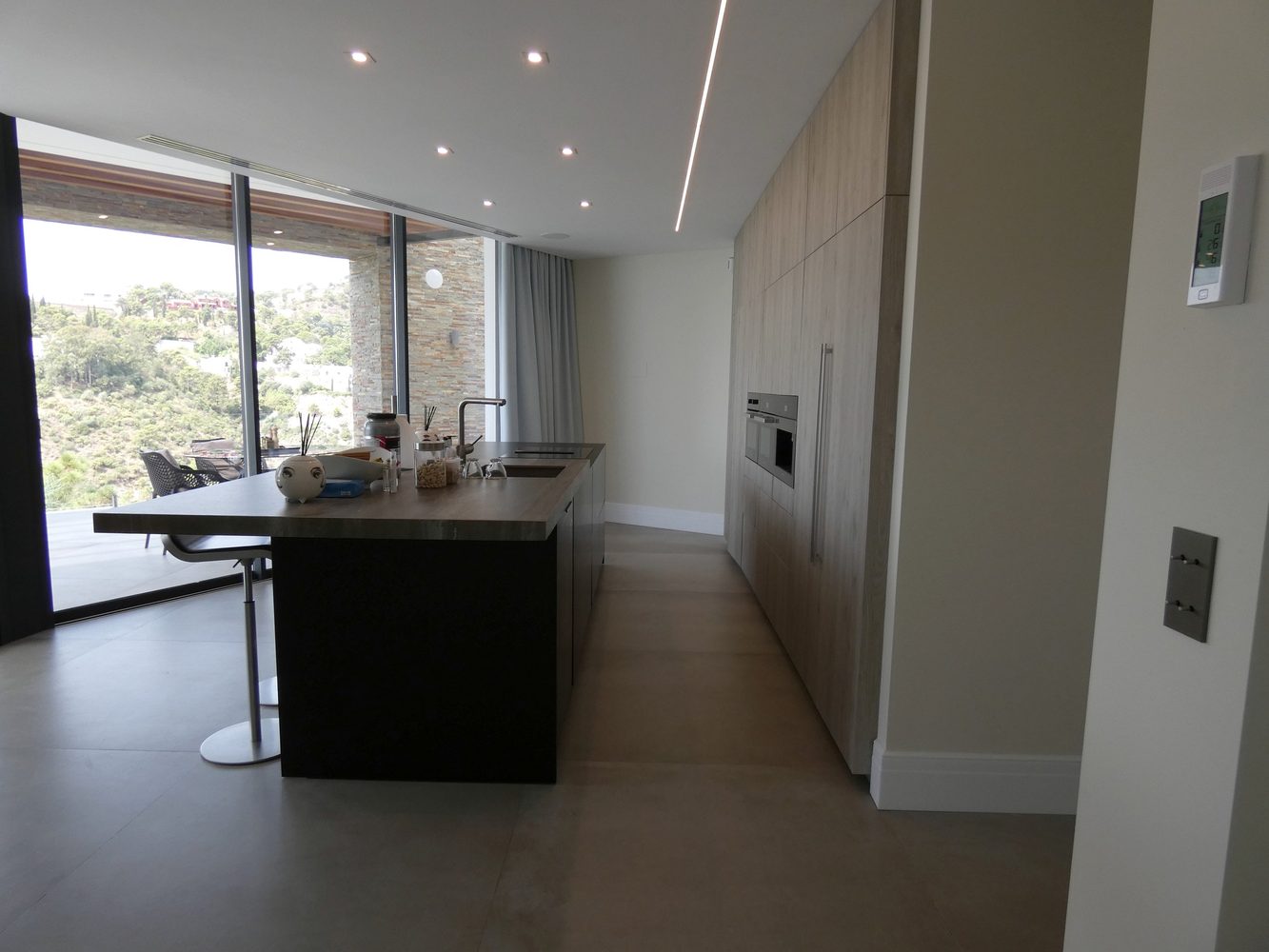Kitchen lighting scene with a wall-mounted smart-home control panel