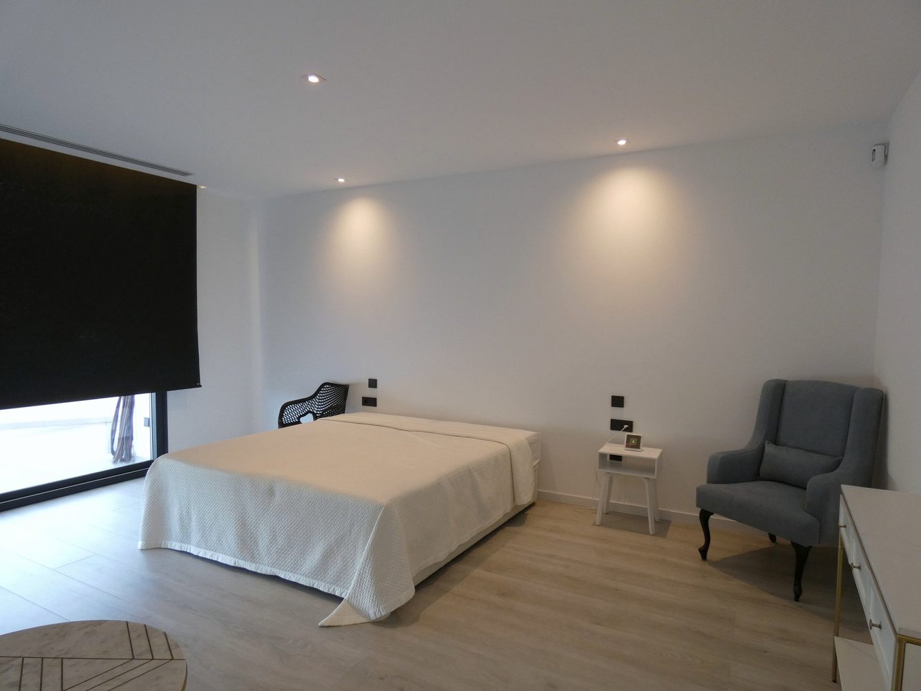 Bedroom with layered lighting and automated blackout curtains