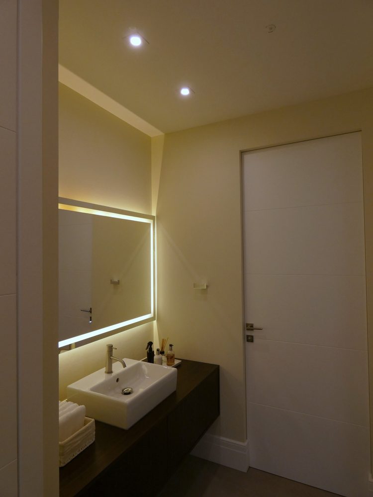 Bathroom with an illuminated mirror and warm lighting scene