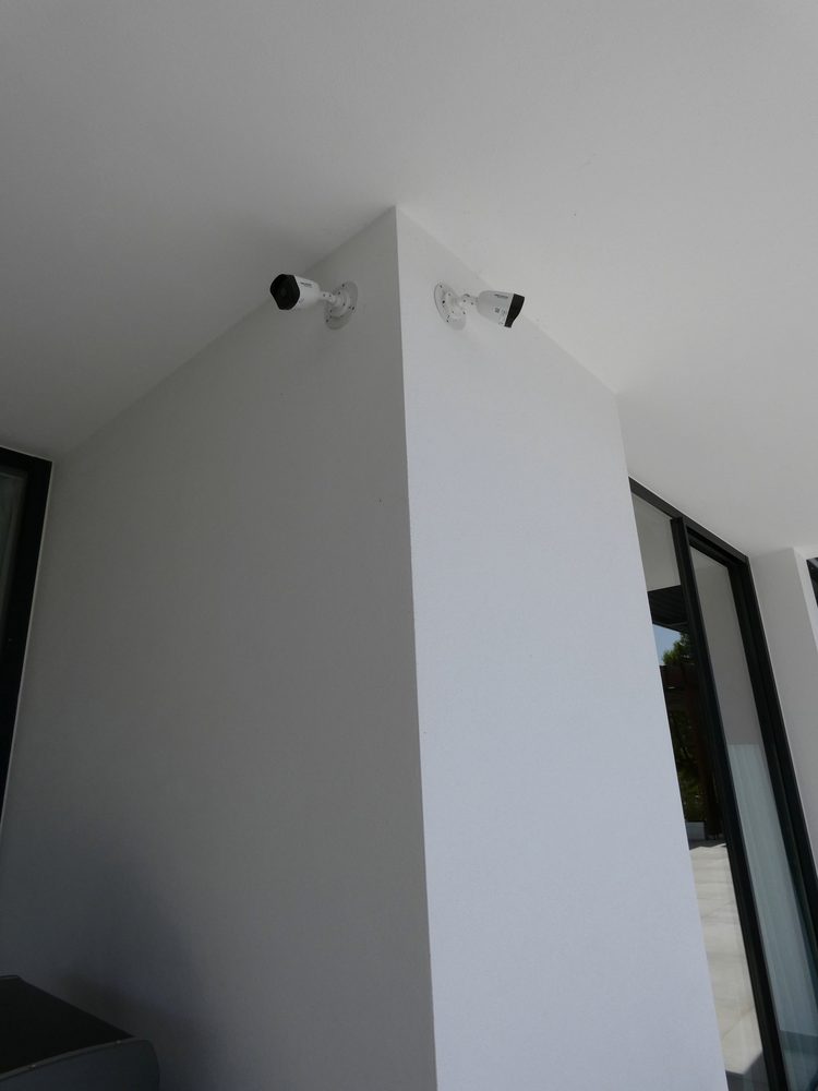 Two security cameras integrated into the villa architecture