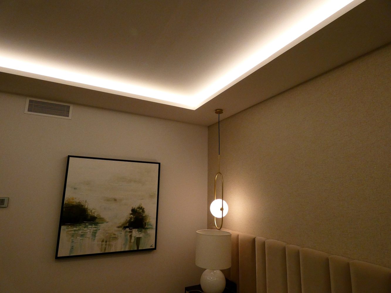 Pendant light and illuminated ceiling cove in the bedroom