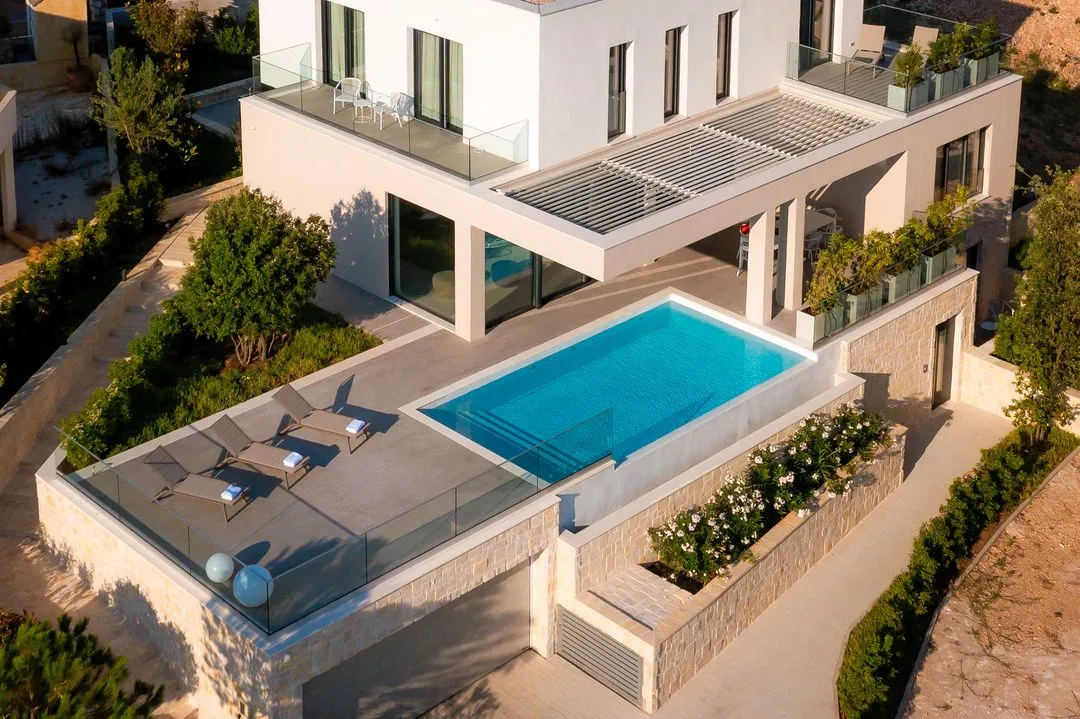 The villa from above with the infinity pool and sun loungers