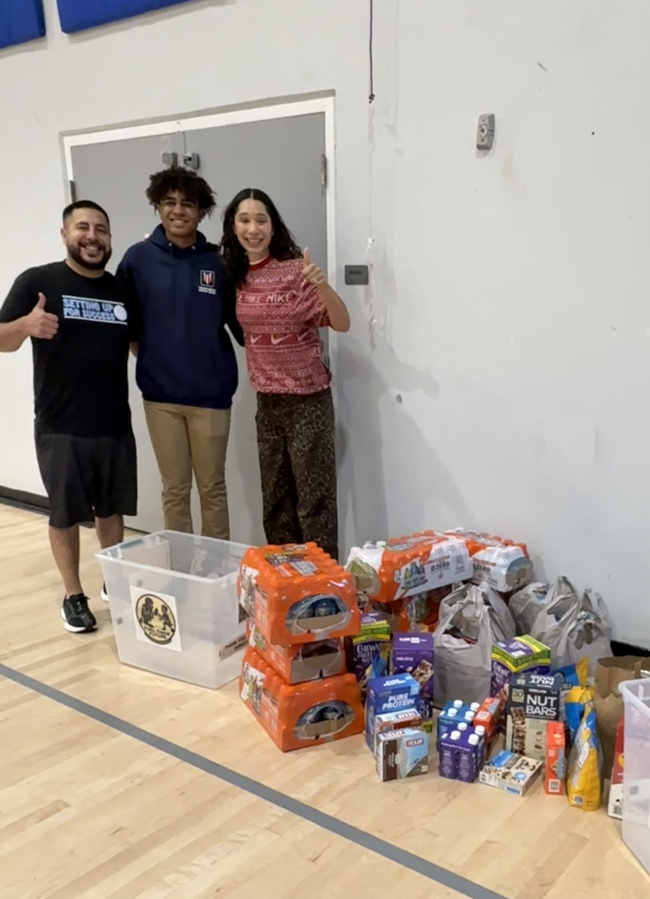A major sports nutrition donation to Boys and Girls Clubs of the Peninsula, received by CEO Jenny Obiaya and Athletic Director Chris DeTrinidad.