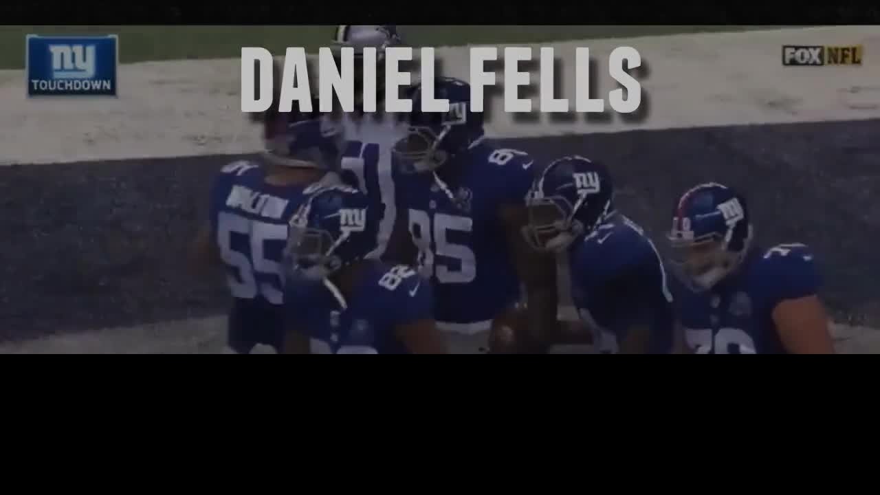 Daniel Fells speaking on stage