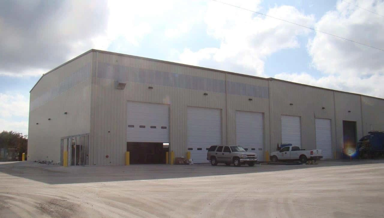 Exterior of the San Antonio maintenance shop with four overhead doors