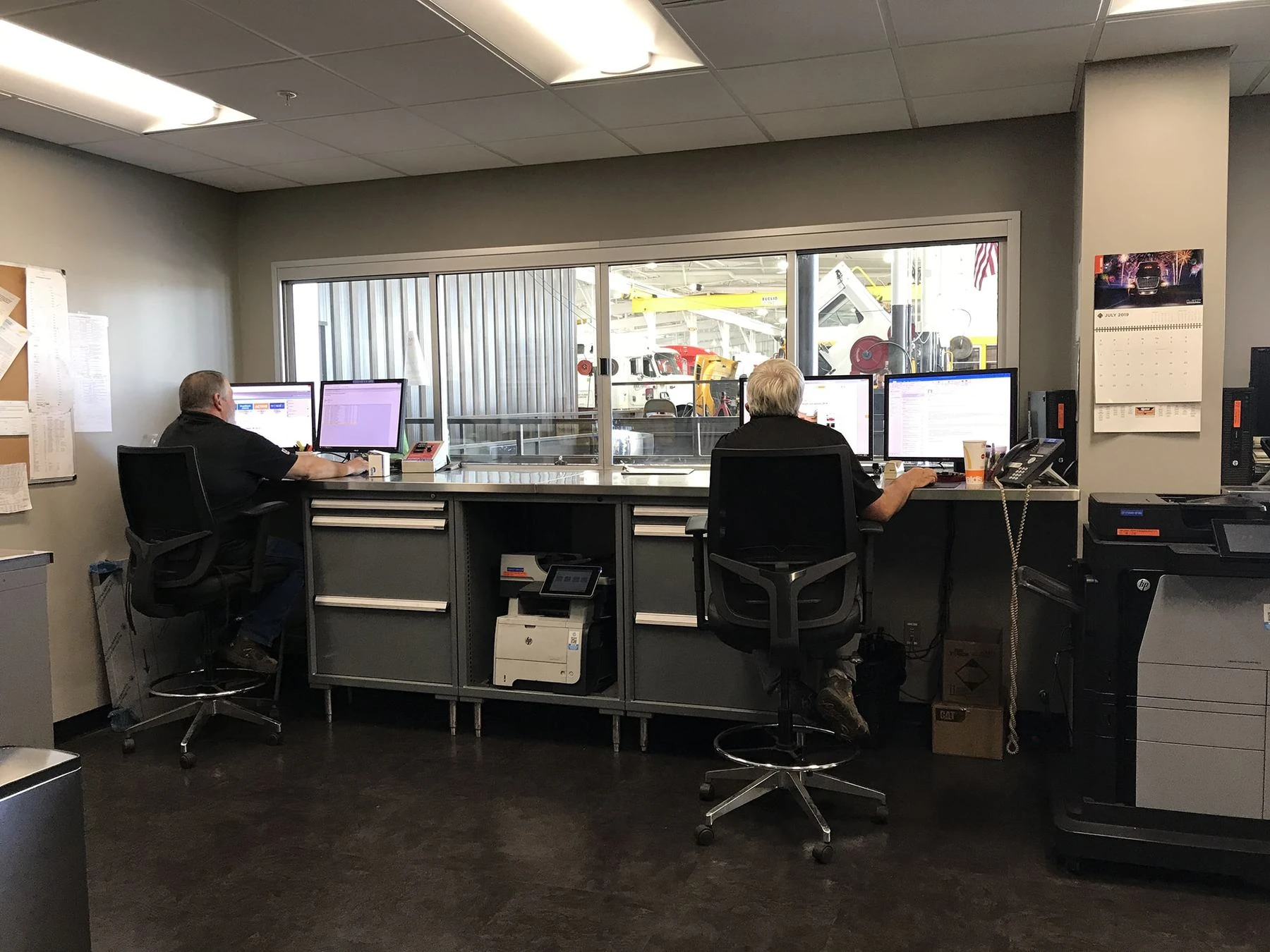 Two service writers working at the Rush Truck Centers service desk