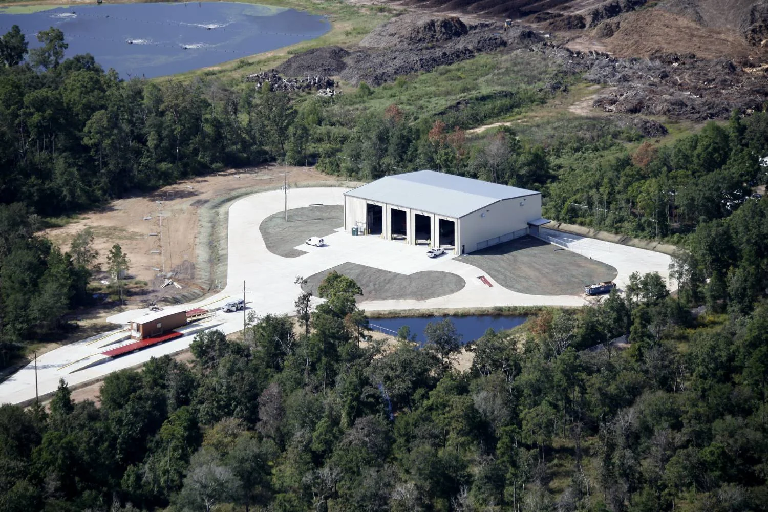 Aerial view of the Conroe transfer station beside the working face of a landfill