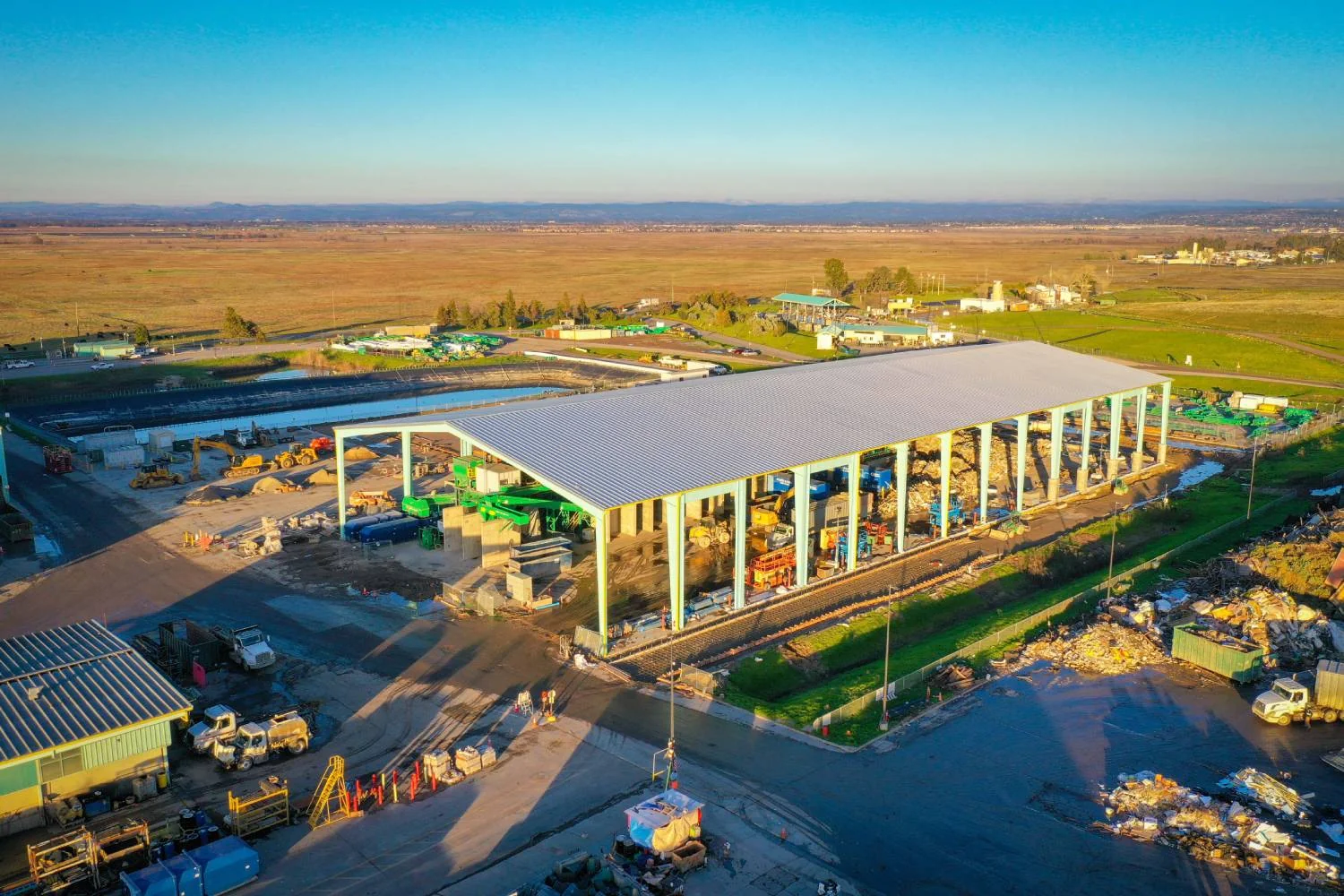 Aerial view of the WPWMA recycling center phase 3 steel structure at sunset