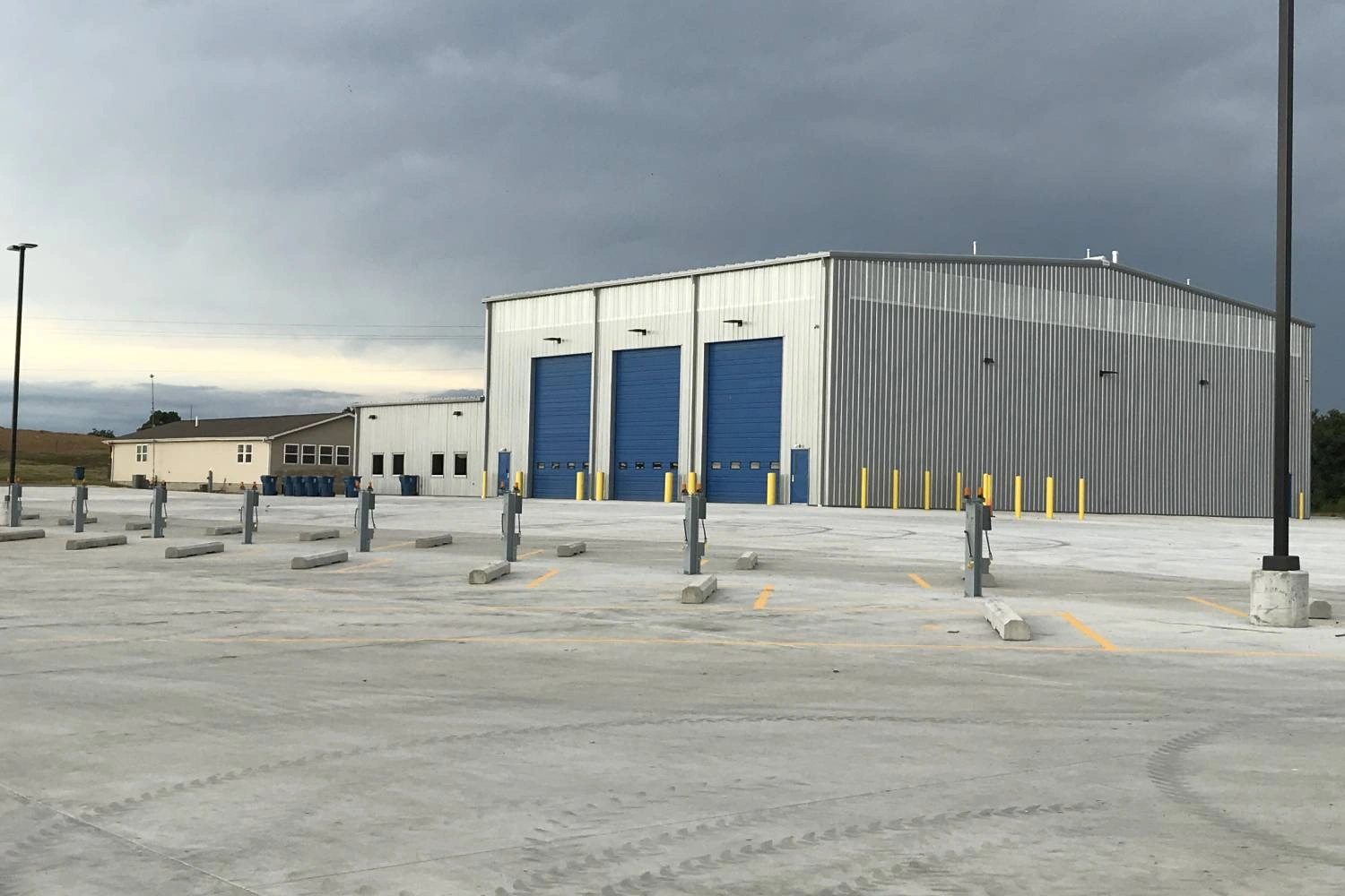 Exterior of the Dexter hauling facility showing the ribbed metal wall and blue overhead doors