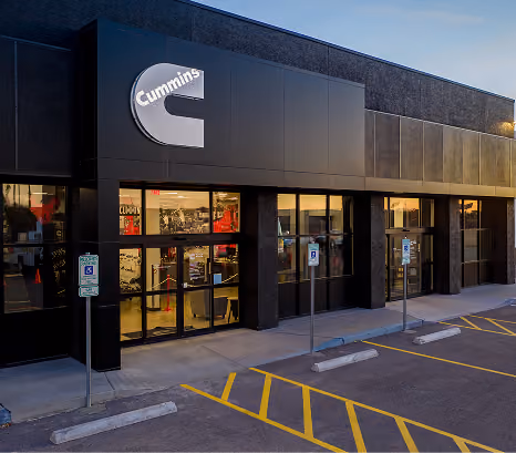 Exterior of a Cummins sales and service building lit at dusk