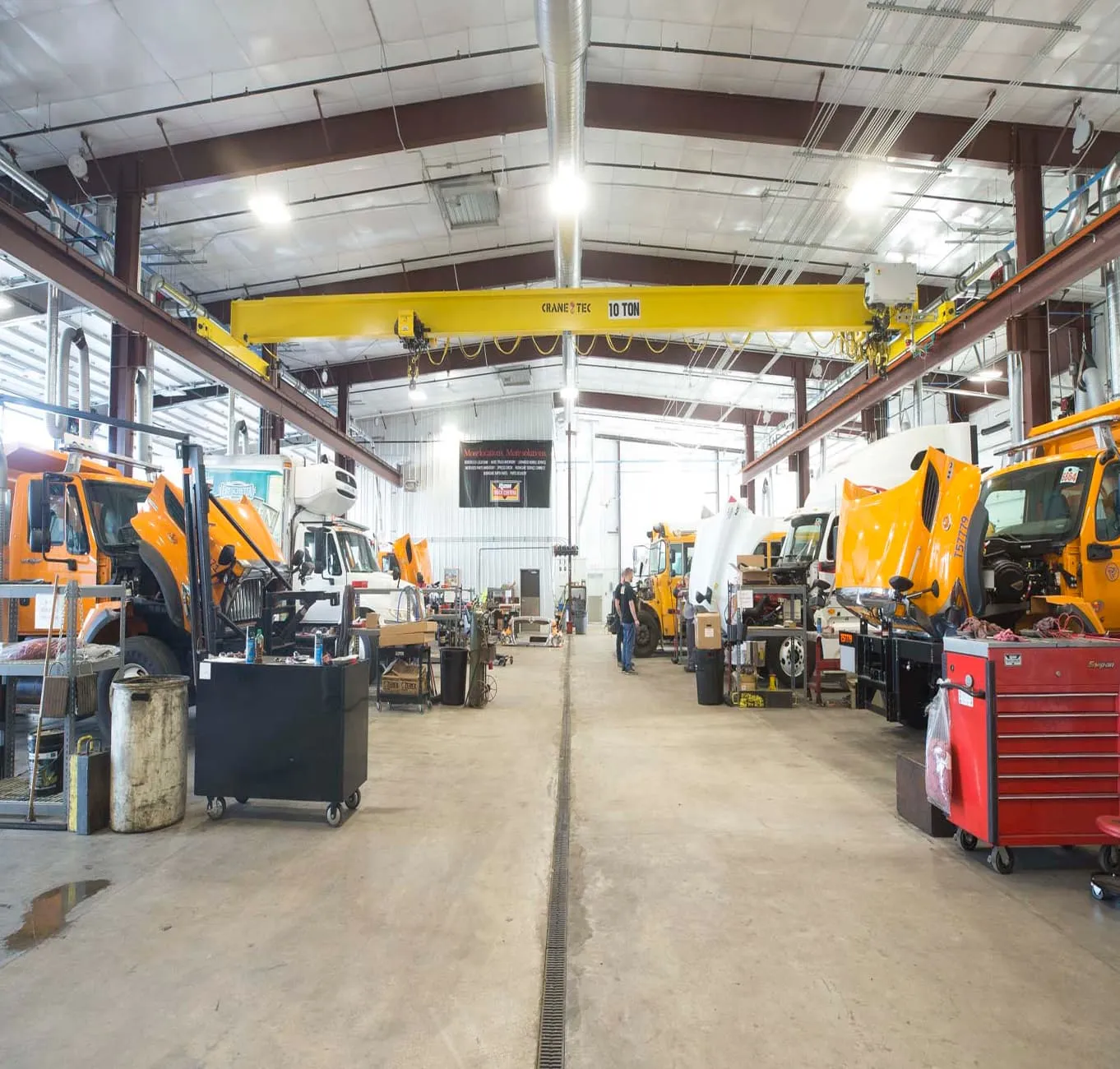 Interior of a maintenance warehouse with an overhead crane and equipment under service