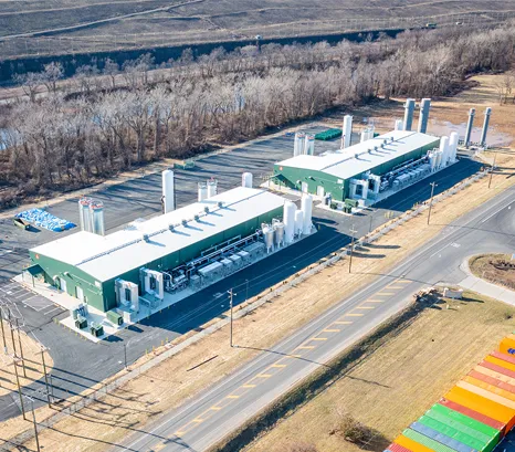 A large-scale renewable natural gas (RNG) facility capturing landfill gas and transforming it into a valuable renewable energy resource. An extensive network of gas collection infrastructure draws methane-rich biogas from beneath the landfill, where advanced processing equipment cleans and upgrades the gas for beneficial use.