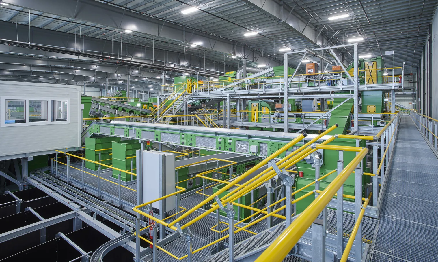 A high-tech material recovery center where advanced automation, optical sorting, and artificial intelligence work together to transform the recycling process. State-of-the-art conveyor systems move a continuous stream of recyclable materials through sophisticated optical sorters that rapidly identify and separate plastics, paper, metals, and other valuable commodities.
