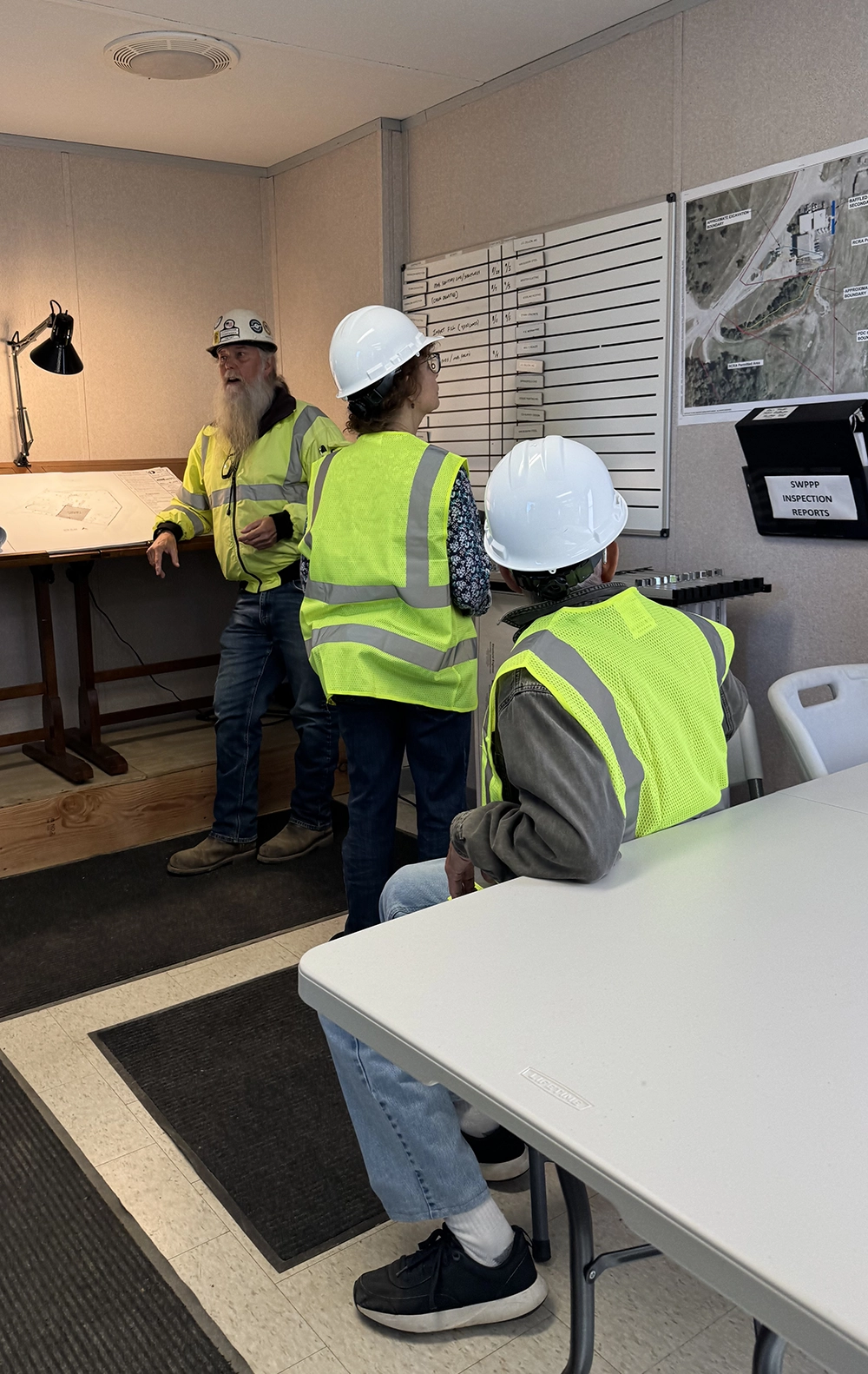 Construction management team in a jobsite trailer building a recycling facility.  
