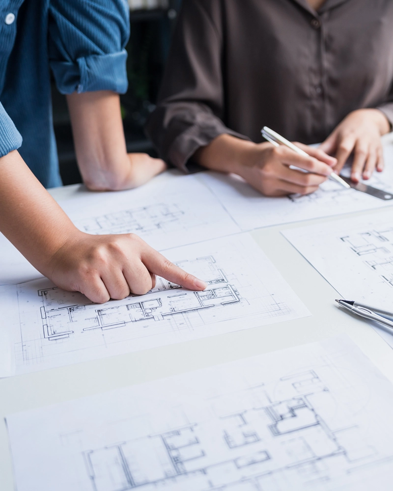 Client and design team reviewing architectural drawings. 