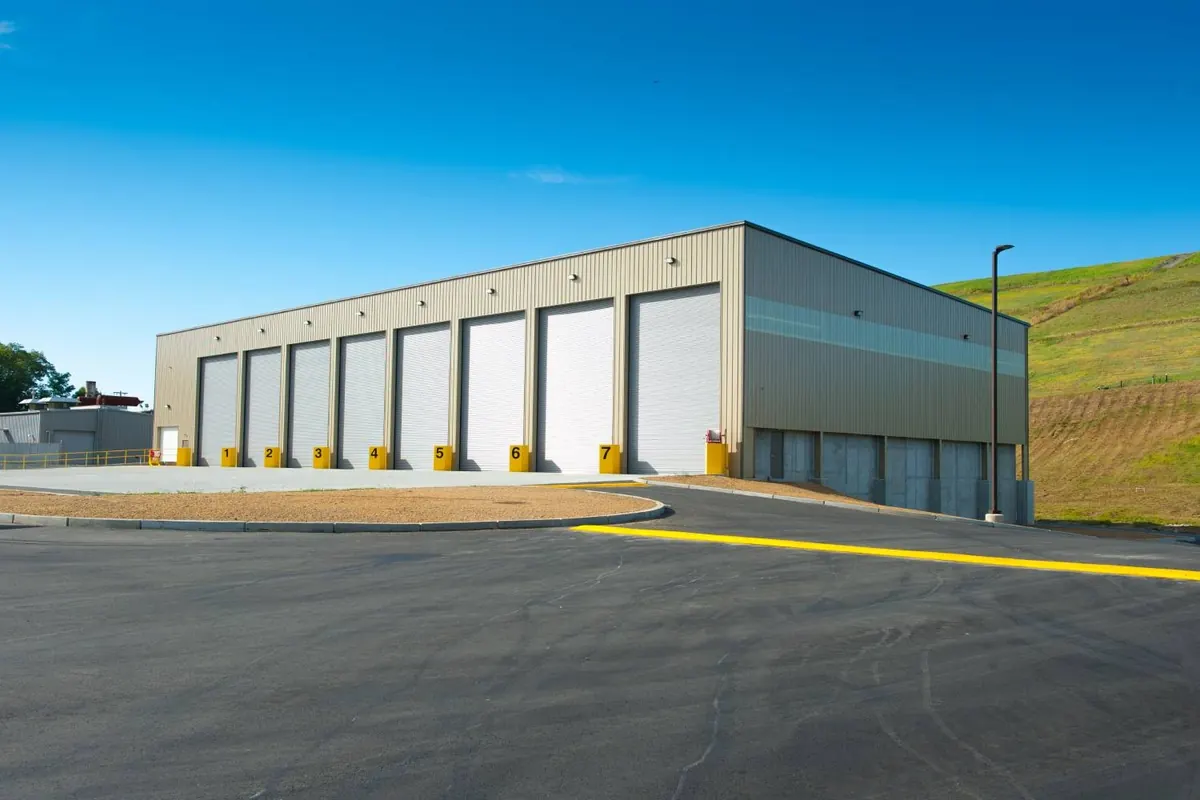 Exterior of the Fall River transfer station with a long row of tipping bay doors
