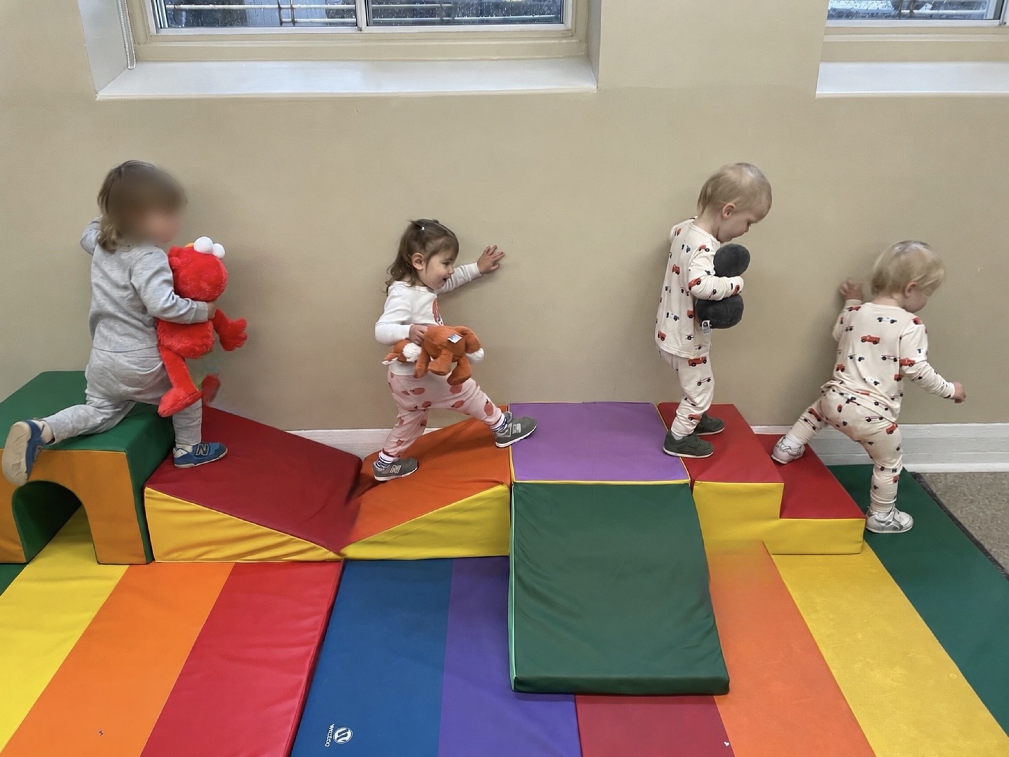 Toddlers playing with blocks in the gym