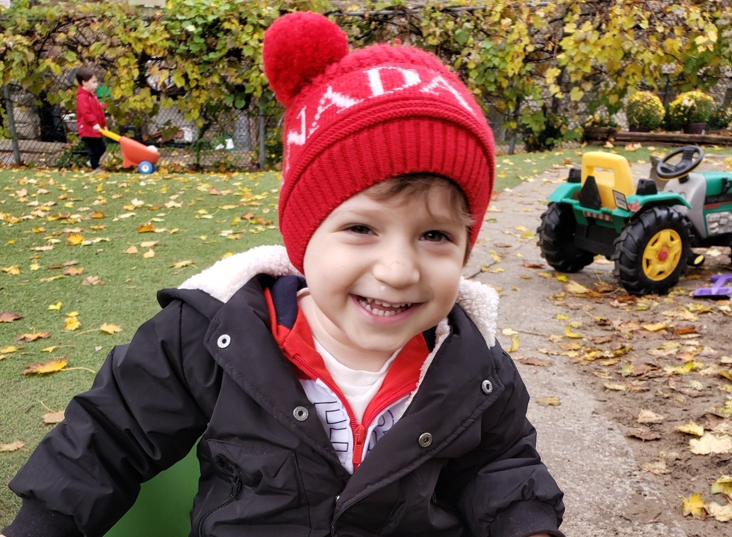 A child smiling in the wagon at pickup