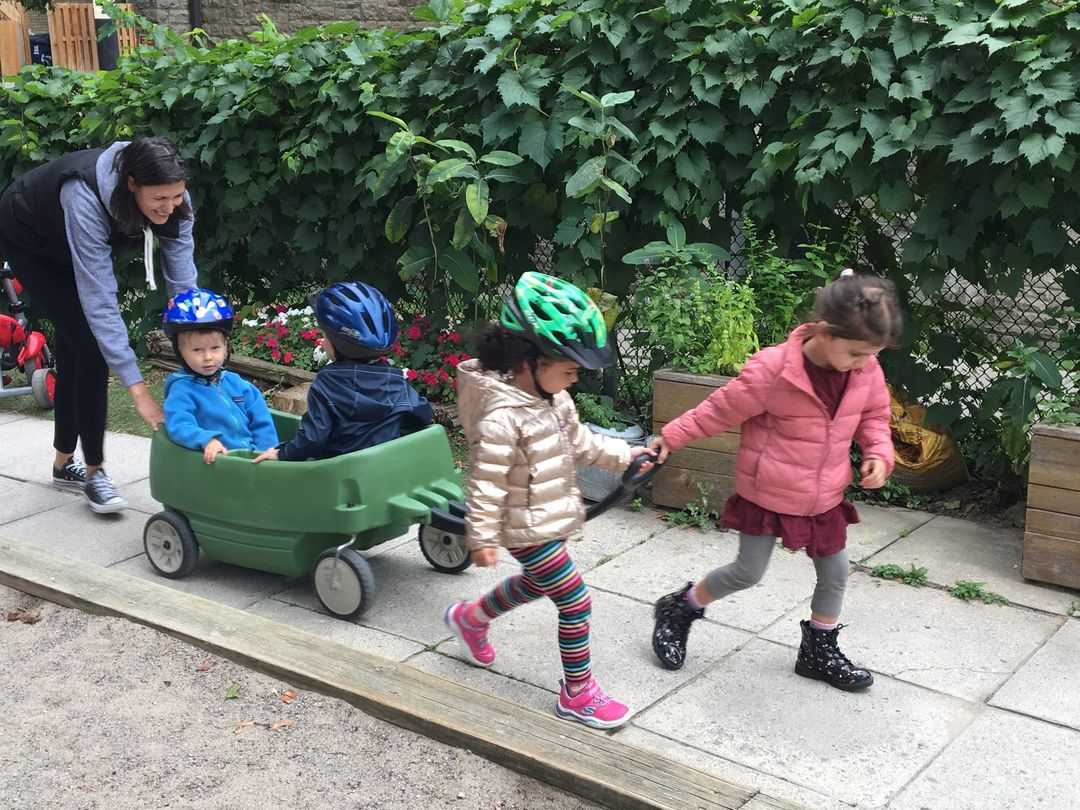 Children pulling a wagon in the Oriole playground