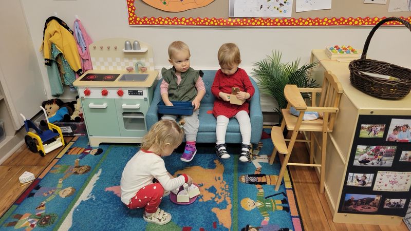 A child at the play kitchen in the classroom
