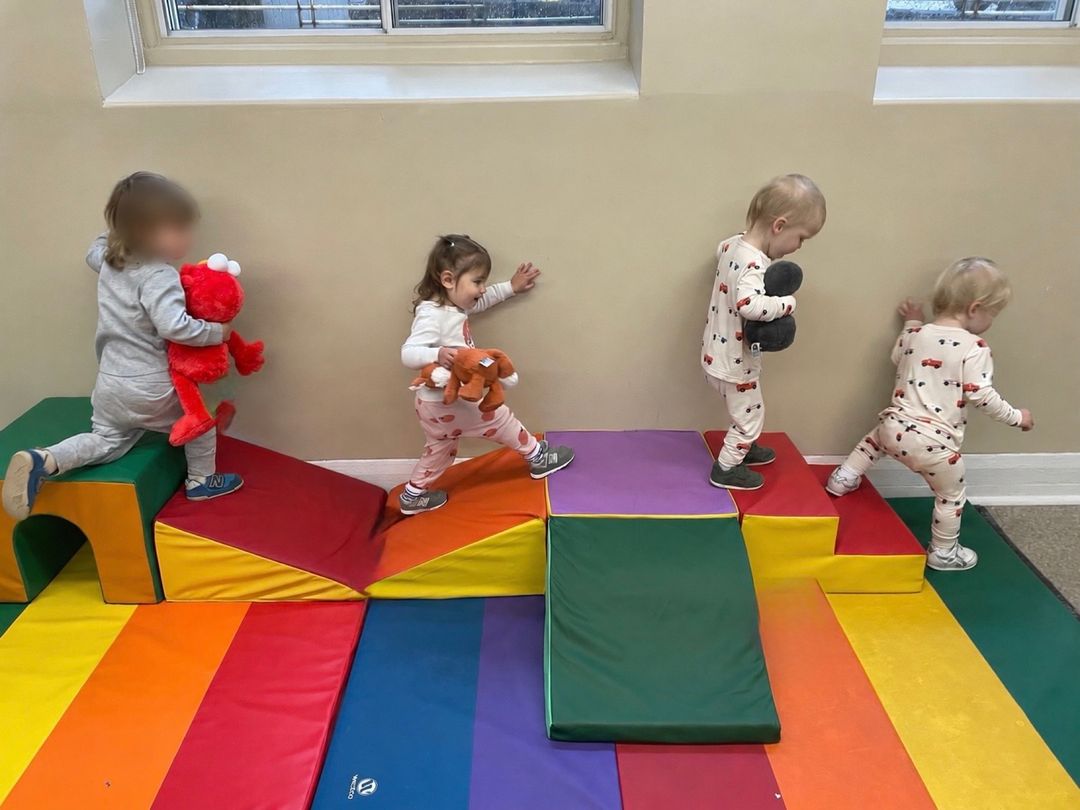 Toddlers playing with blocks in the gym