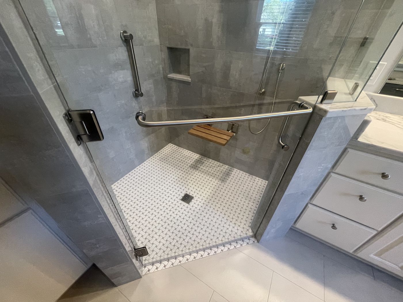 Frameless glass shower with mosaic tile floor — Daybreak Construction