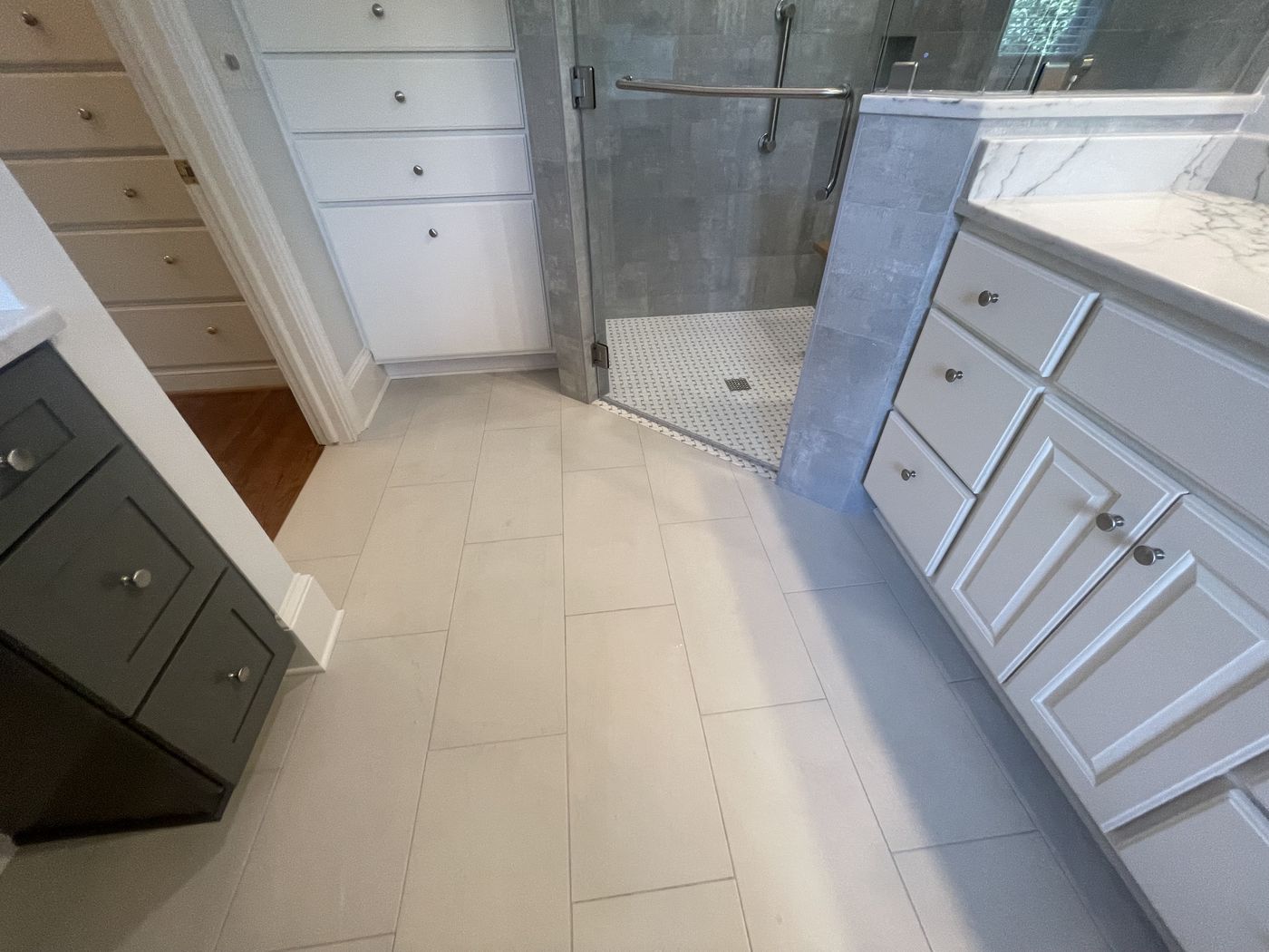 Bathroom remodel with custom cabinetry and tile flooring — Daybreak Construction