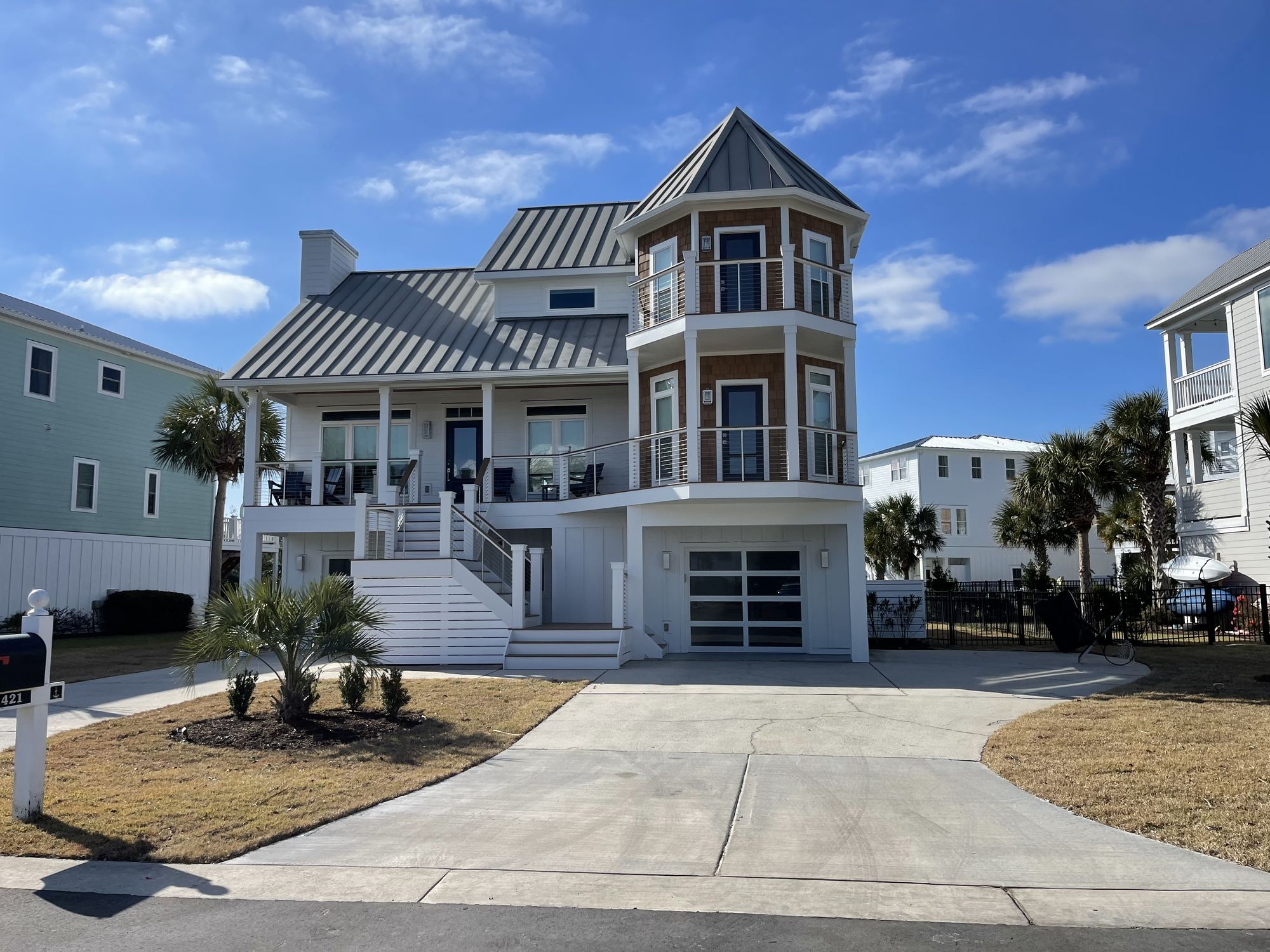 Custom three-story coastal home with turret and metal roof — Daybreak Construction