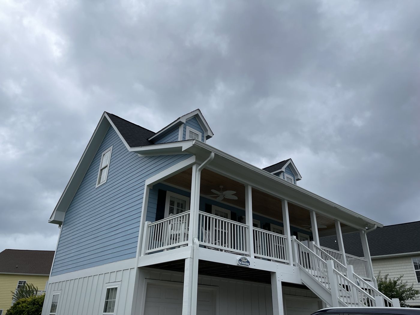 Two-story coastal home with wraparound porch — Daybreak Construction