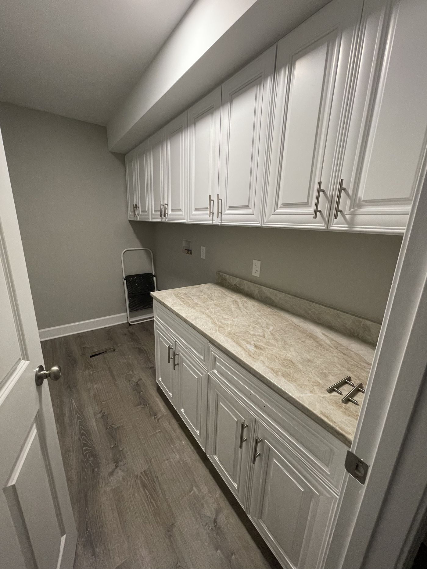Laundry room cabinetry with quartz folding counter — Daybreak Construction
