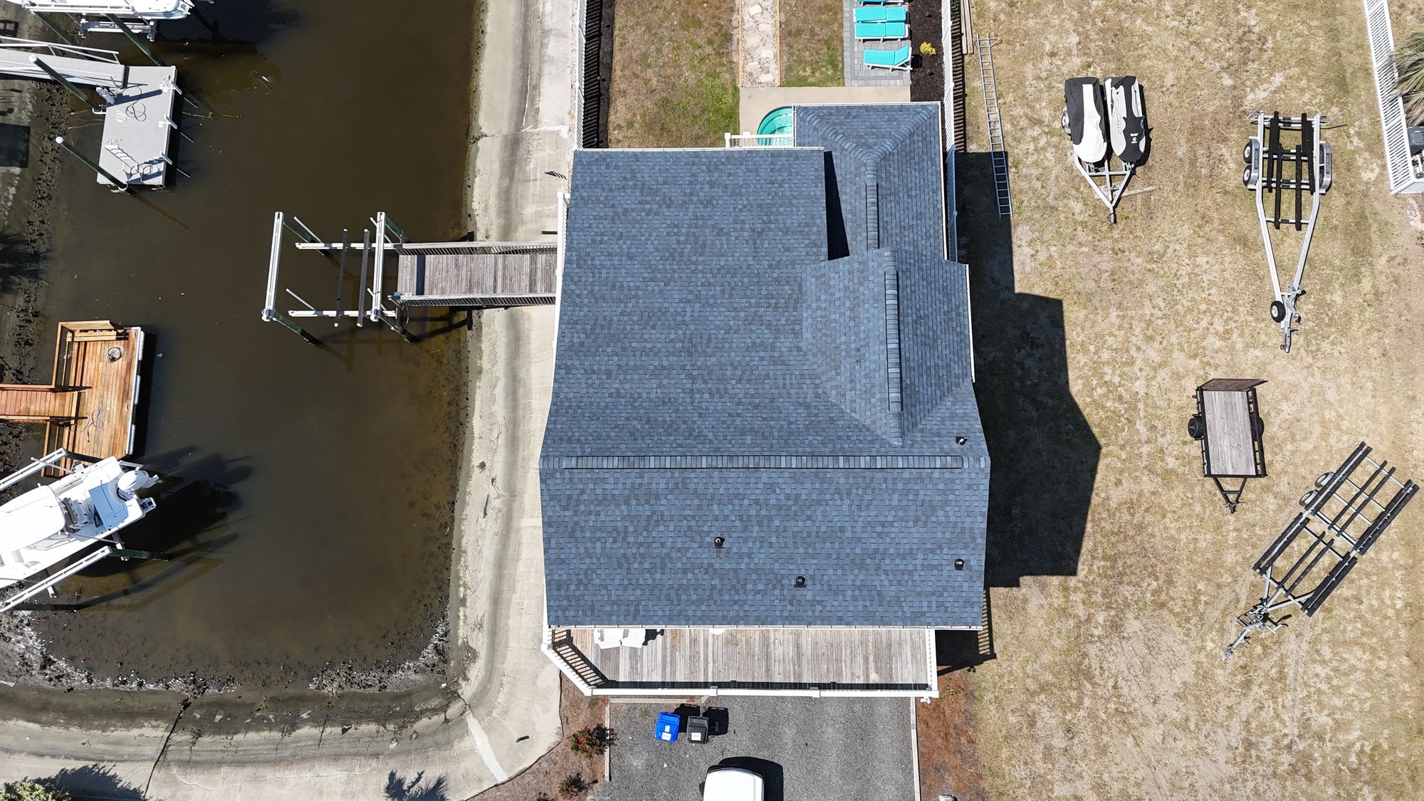 Aerial view of a completed architectural shingle roof on a waterfront home — Daybreak Construction
