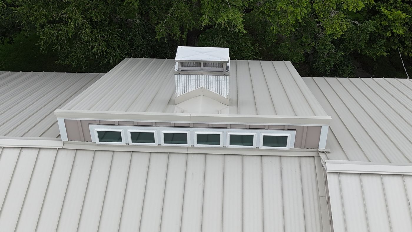 Metal roof ridge and chimney detail from above — Daybreak Construction