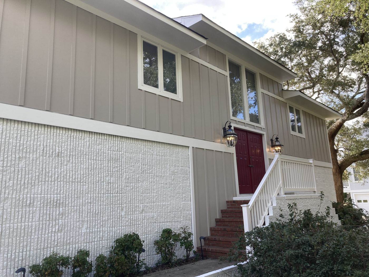 Exterior remodel with painted brick and board-and-batten siding — Daybreak Construction