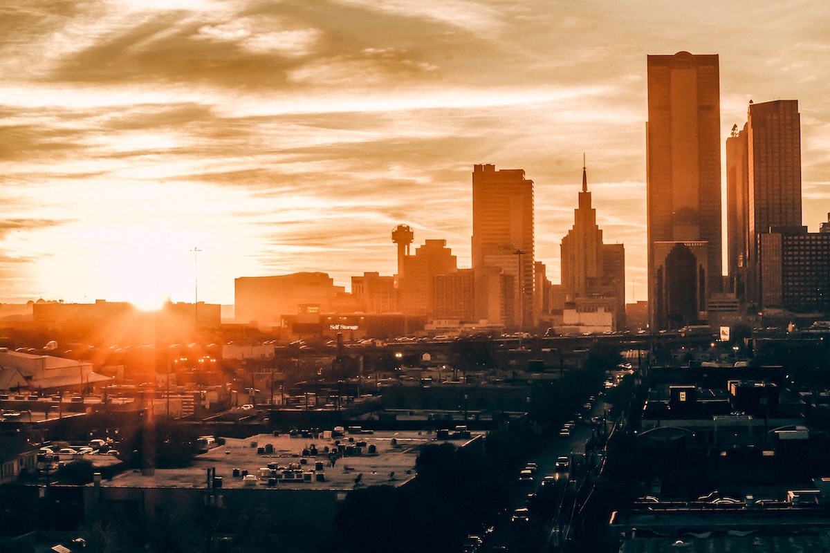 Stunning Dallas skyline at sunset, showcasing vibrant colors and iconic architecture.