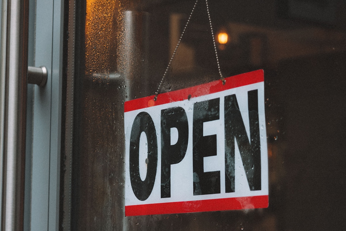Inviting café entrance featuring an open sign on a glass door.