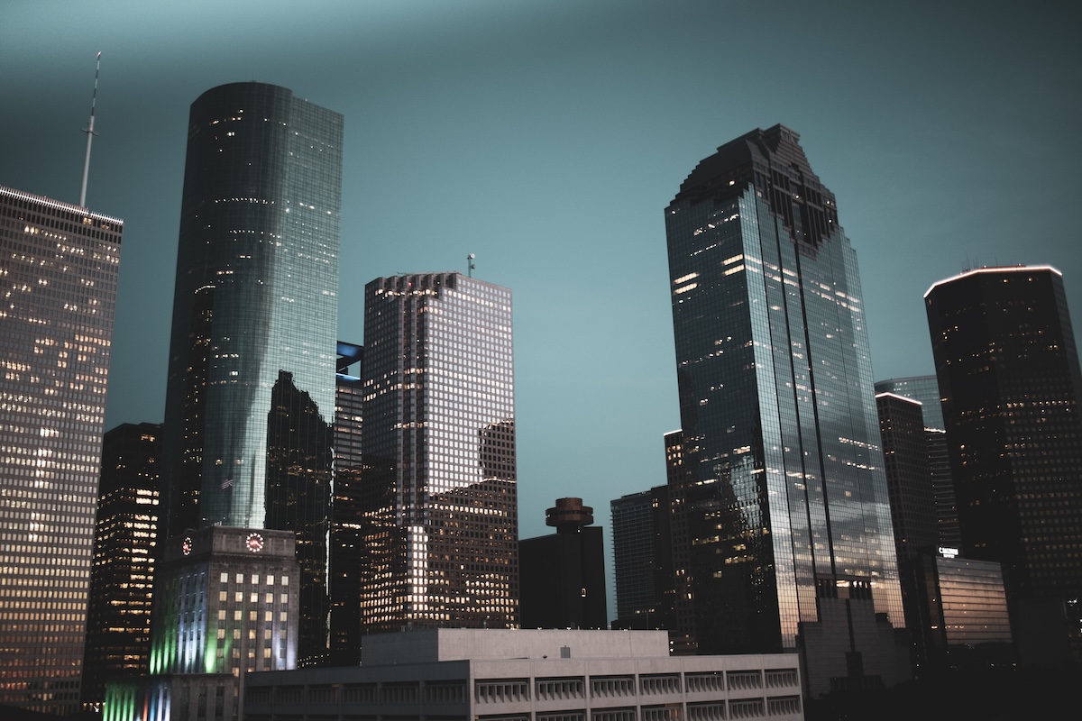 Nighttime view of Houston's modern skyline featuring illuminated skyscrapers against a dark sky where Hammer & Nails franchises flourish.