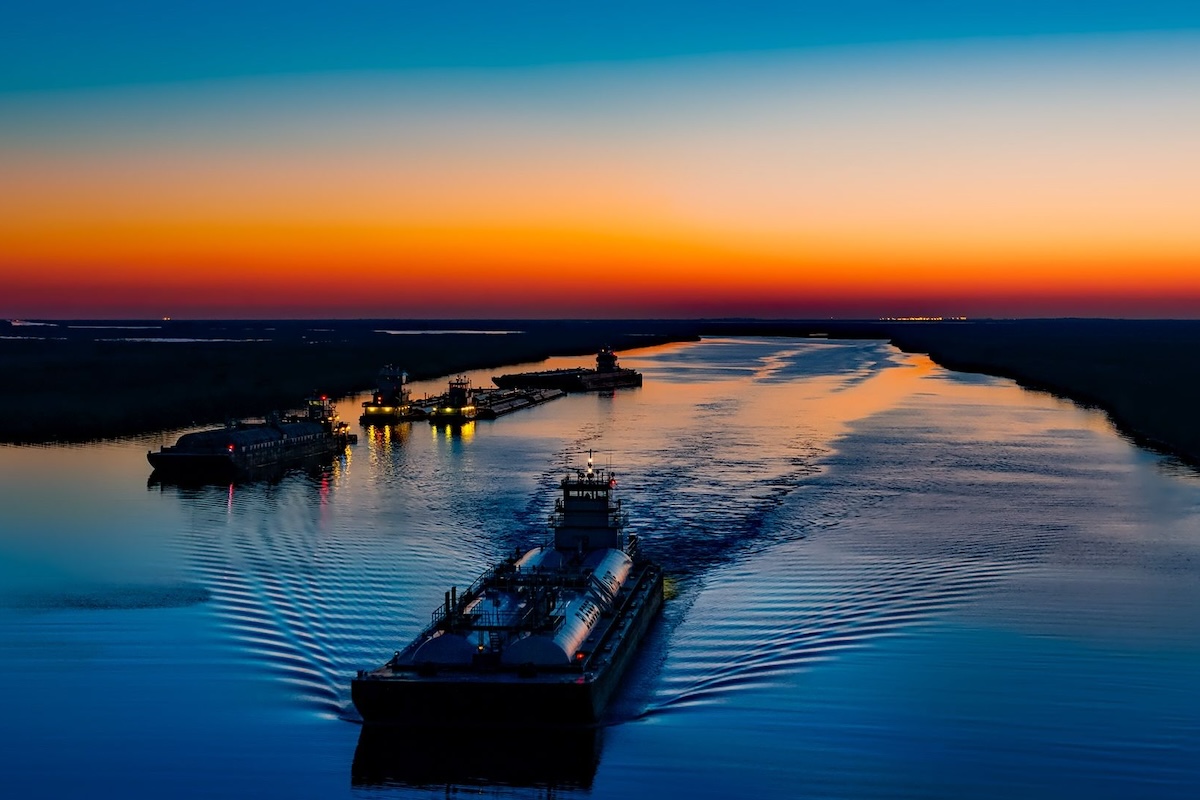 Serene twilight view of boats on the river in Port Arthur, Texas, USA.