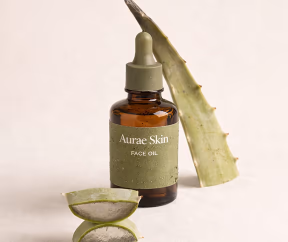 Amber glass dropper bottle of WrinkleMD Youth Serum HA with fresh aloe vera leaves in the background.