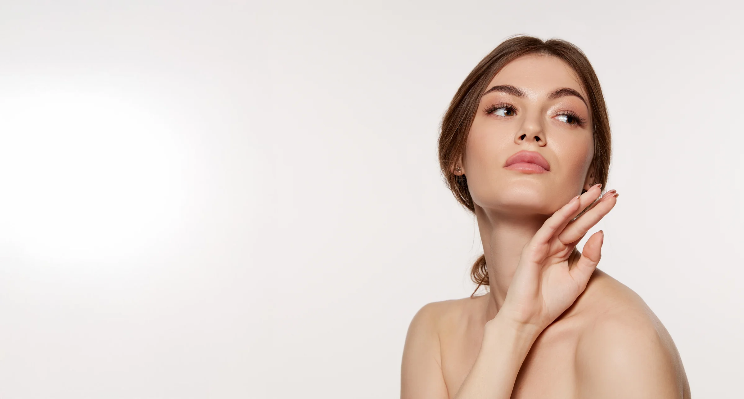 woman with hands under face
