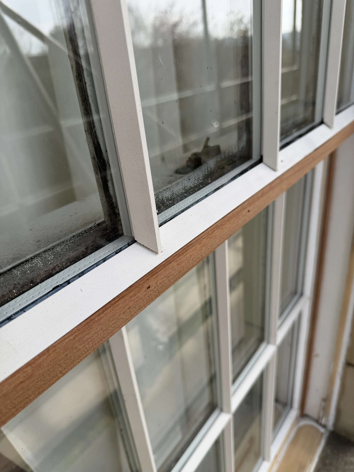 Close-up of a timber sash window meeting rail during restoration.