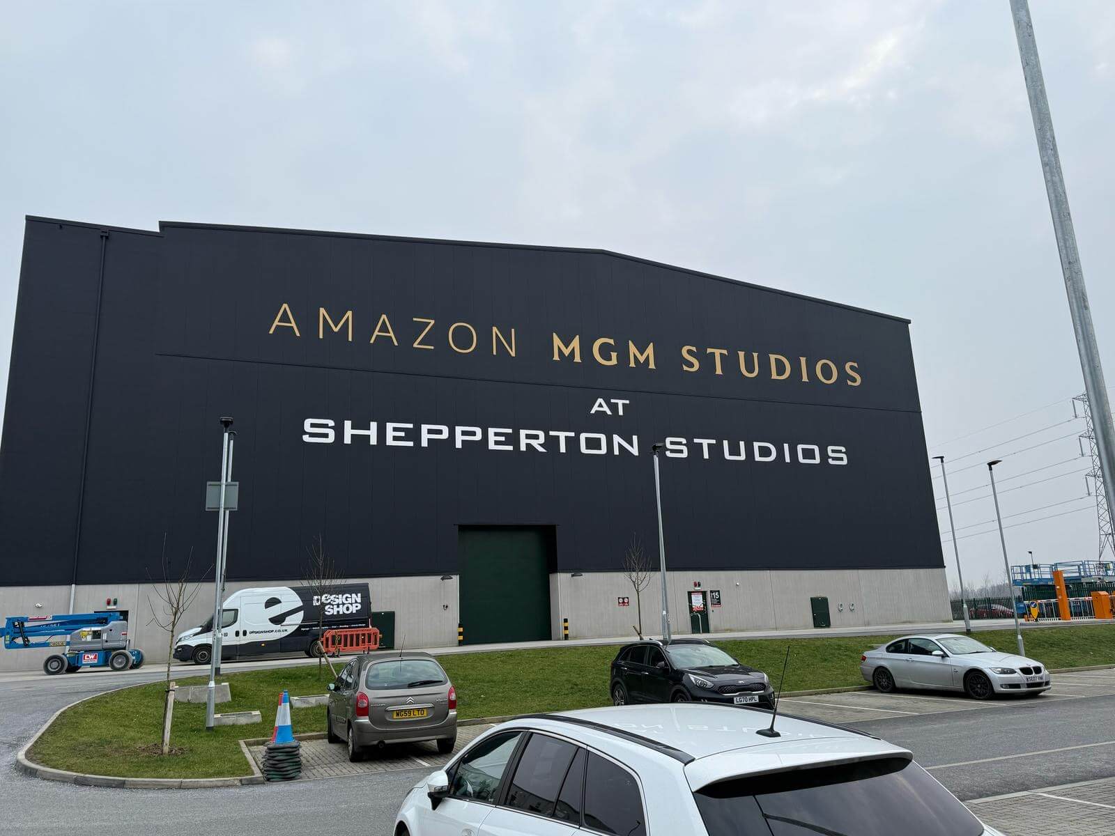 Amazon MGM Studios sign on the dark facade at Shepperton Studios.